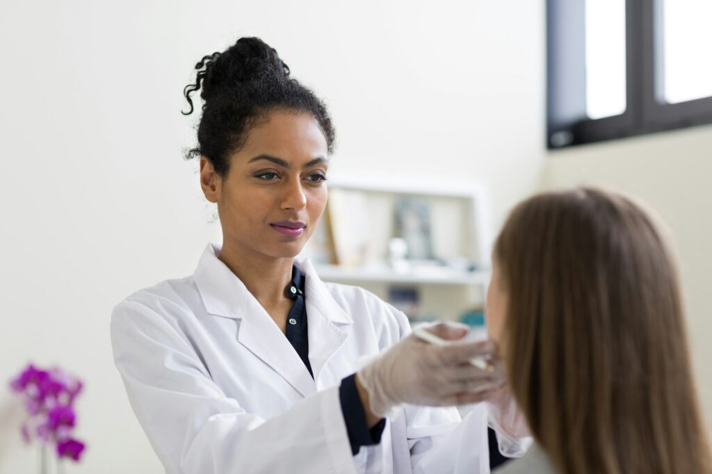 Cosmetic surgeon marking patient's face for surgery